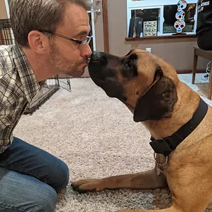 Daman kissing a dog