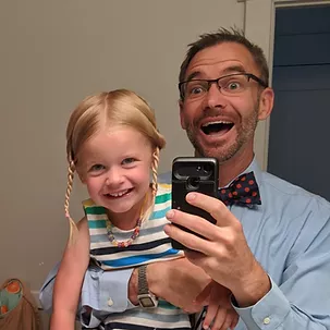Daman taking a mirror selfie with a young relative.